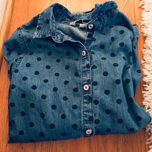 A navy blue poka-dot collared button down shirt